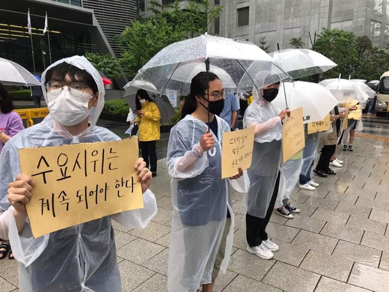 24일 서울 종로구 옛 일본대사관 앞에서 제1445차 정기 수요시위가 진행된 가운데 대학생들이 장마비를 맞으며 자리를 지키고 있다.