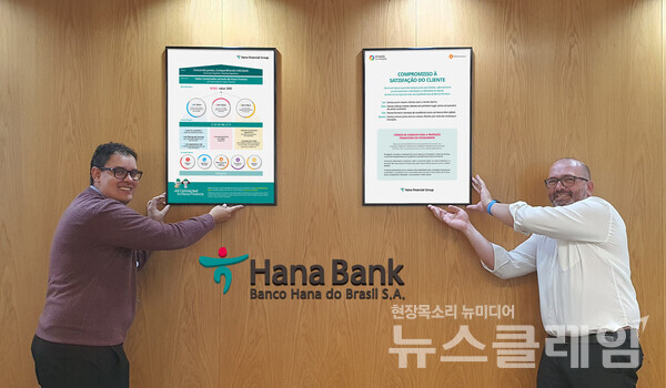 하나은행 브라질 법인의 현지 직원들이 손님이 가장 우선이라는 그룹의 '손님 가치'를 담은 '손님행복헌장'을 벽면에 설치하며 기념촬영을 하고 있다. 사진=하나금융그룹