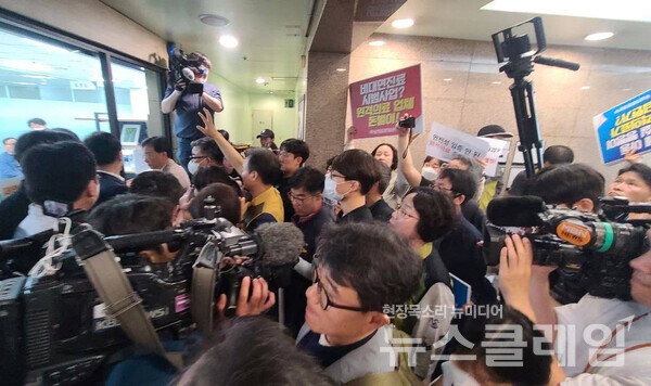 무상의료운동본부는 30일 오전 건강보험정책심의위원회가 열리는 국제전자센터에서 기자회견을 열었다. 회의장 진입을 정부 측 인사들이 막아서며 강경 대치가 이어졌다. 사진=보건의료노조