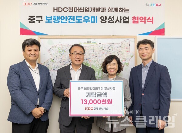 (왼쪽 두 번째부터)신왕섭 HDC현대산업개발 실장과 김남희 중구 경제문화국장이 기념 촬영을 하고 있다. HDC현대산업개발 제공